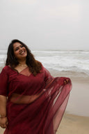 Model smiling in Blood Red Organza Saree, lightweight sheer drape in motion — festive wear saree by Label Anaira