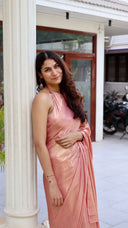 Woman in Blushing Bride Pink Satin Silk Saree standing by a white pillar — rose pink shimmer saree, Label Anaira
