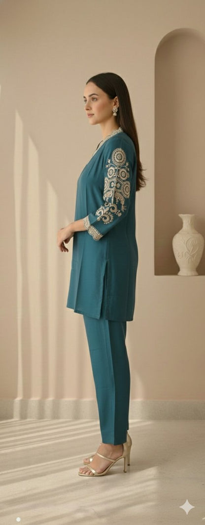 Side view of evergreen co-ord set showing straight silhouette and sleeve embroidery