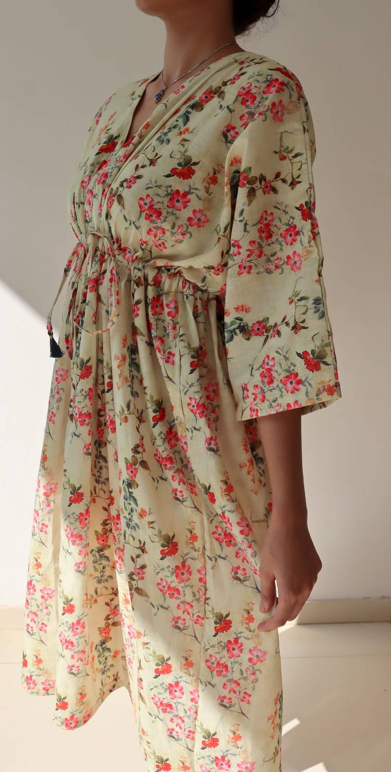SIde view of floral linen dress with flowy silhouette