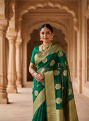 Model wearing green Banarasi organza saree with gold woven motifs and traditional border, styled with temple jewellery 