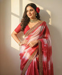 Close-up of Gulnaar Grace organza saree highlighting red and ivory tones with gold border