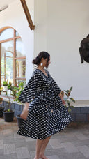 Full length view of black polka dot satin dress for women