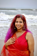 Woman in Queen Bee Honey Organza Saree at the beach — honey gold-orange sheer nylon organza, Label Anaira