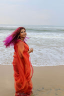 Full-length view of Queen Bee Honey Organza Saree by the sea, lightweight sheer flow — Label Anaira