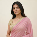Close-up of Rosé Veil pink organza saree showcasing gold scalloped border detail