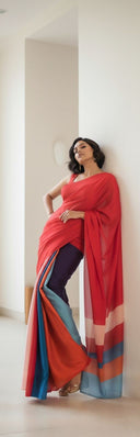 Scarlet red satin saree styled with multi-tone pallu and minimal jewellery