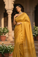 Model wearing sunlit gold linen tissue saree with soft olive undertones and subtle gold sheen, styled for festive occasions.