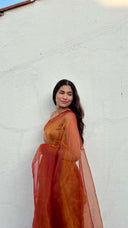 Drape view of The Sunset Debutante saffron organza saree by Label Anaira featuring flowing lightweight organza in a glowing saffron orange shade.