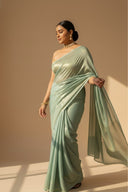 Model wearing teal satin silk saree with gold shimmer for festive and wedding wear