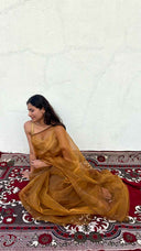 Front view of The Season’s Golden Darling Gold Organza Saree by Label Anaira, a lightweight sheer gold organza saree perfect for weddings and festive occasions.