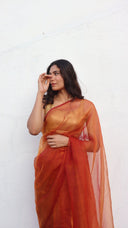 Drape view of the Whispers by Candlelight ember organza saree by Label Anaira featuring flowing lightweight organza in a rich burnt orange shade.