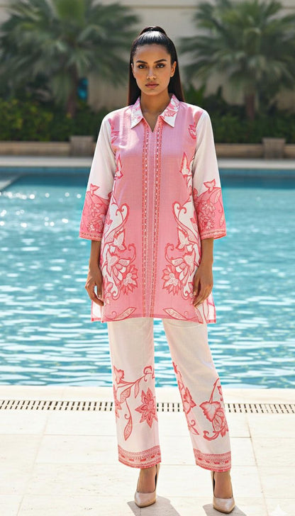 woman wearing label anaira pink and white beautiful co-ord set with pool in the back